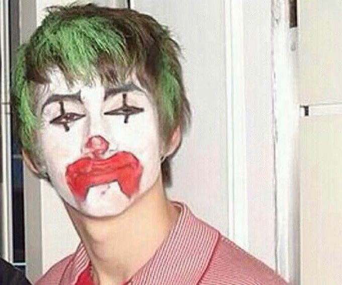 a man with green hair and clown makeup