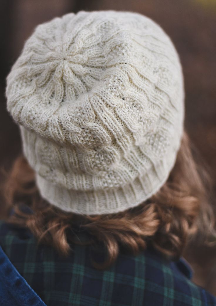 a woman wearing a white knitted hat