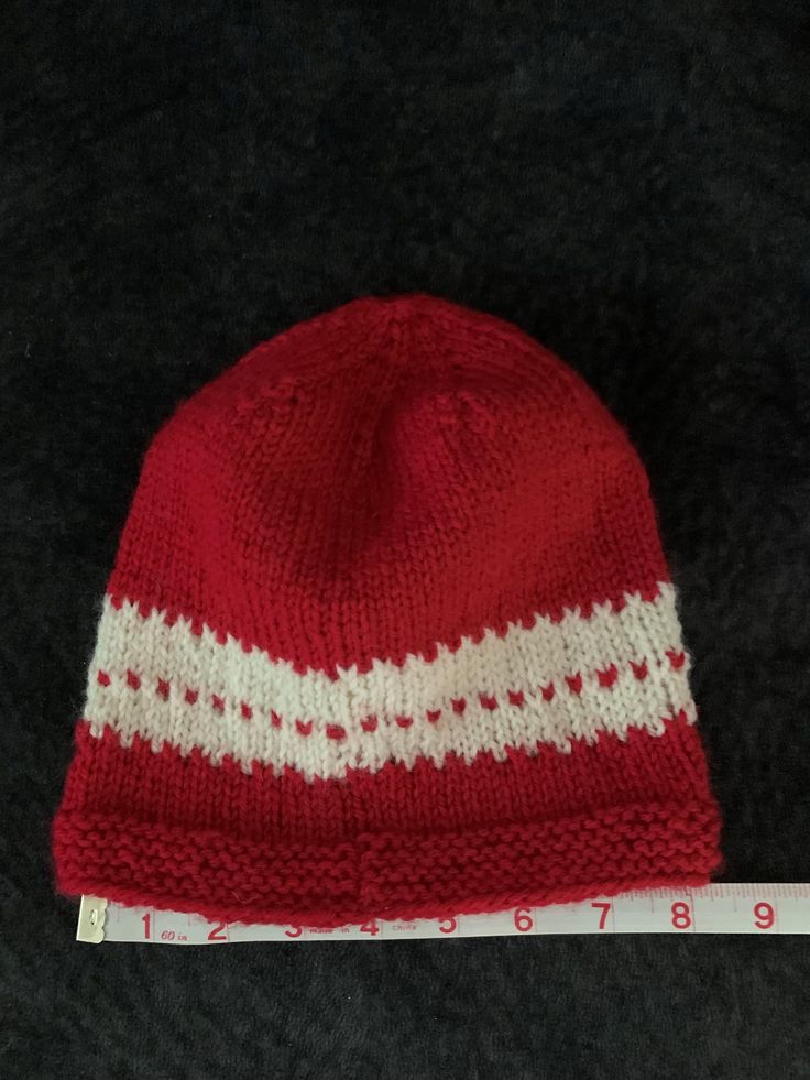 Beautiful red and white winter stocking cap. Hand knit with a wool mix yarn so it will keep your head warm and toasty on cold winter days. This stocking cap has quite a bit of stretch and will comfortably fit most people. Winter Stockings, Stocking Cap, White Hand, Winter Days, Winter Day, Winter Knits, Winter White, Cold Winter, Your Head