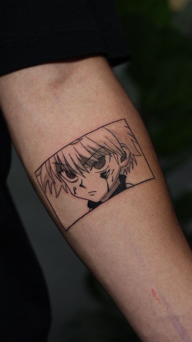 a person with a black and white anime tattoo on their arm, holding a cell phone