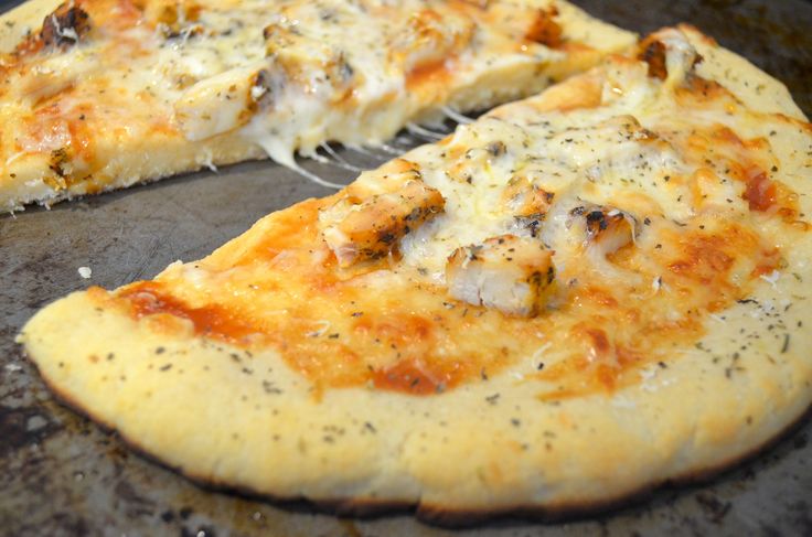 a close up of a pizza on a pan with a spatula in it's hand