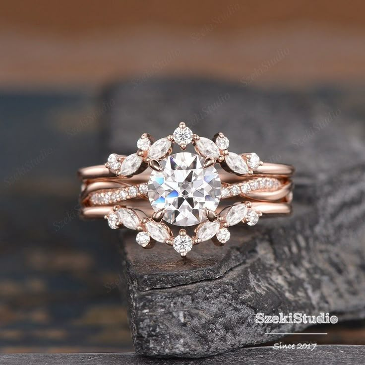 a close up of a diamond ring on a rock