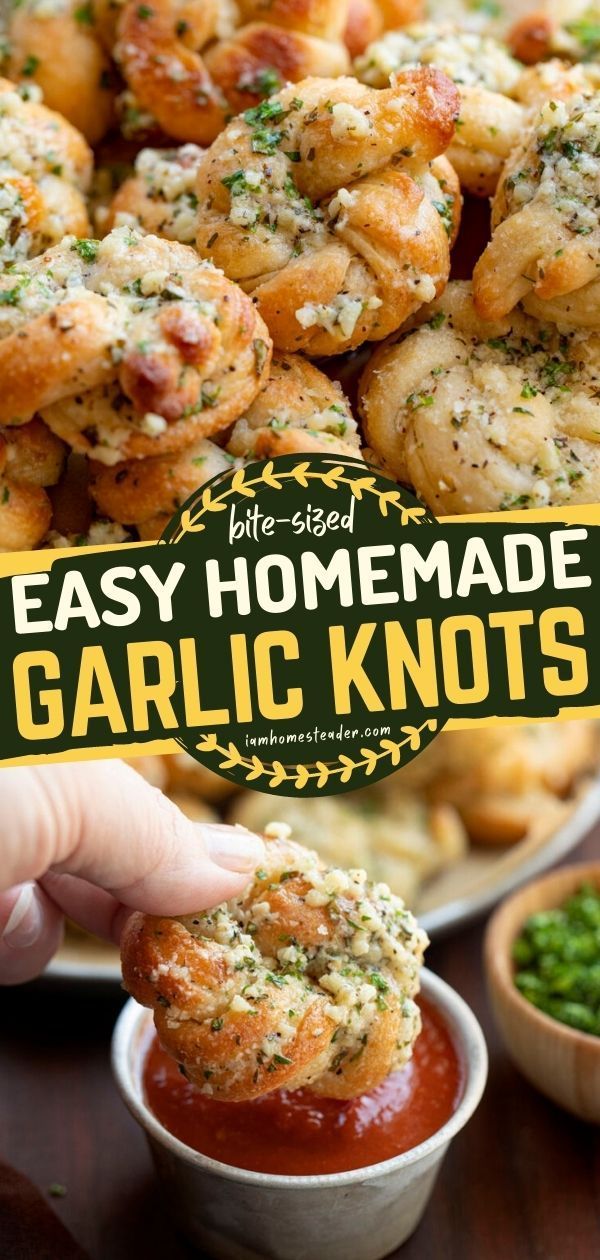 the homemade garlic knots is being held up by someone's hand and dipping them into a small bowl