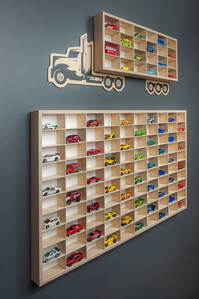 two wooden shelves filled with toy cars on top of a wall next to each other