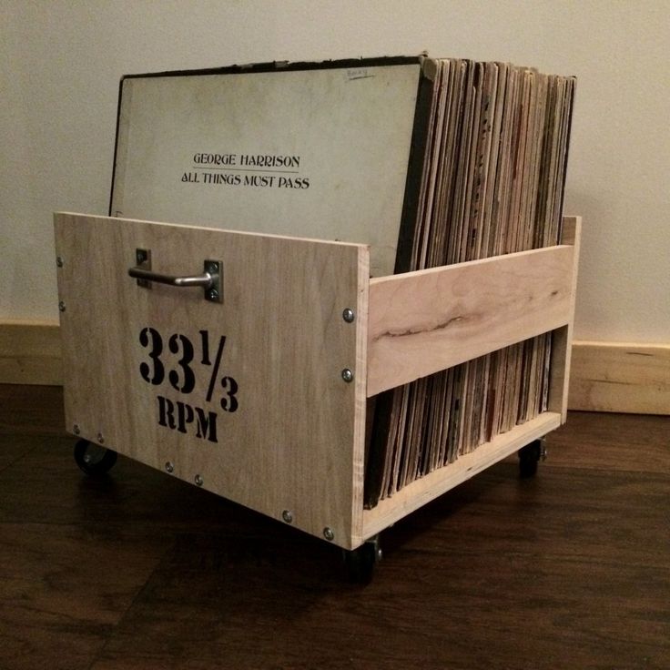 an old record player sits on the floor with records in it's storage compartment