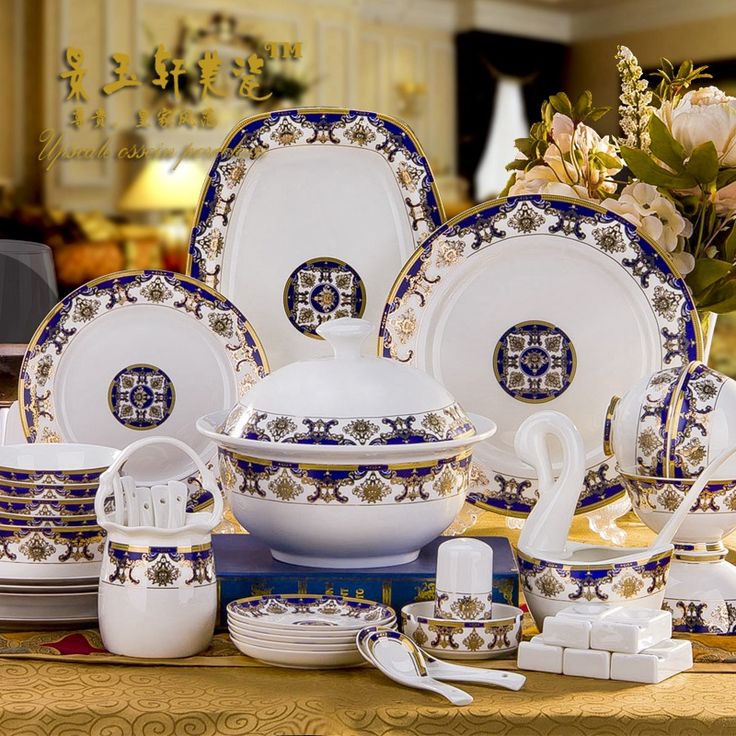 a table topped with lots of white and blue dishes