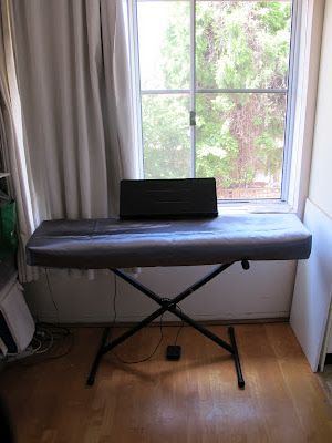 an ironing board sitting in front of a window