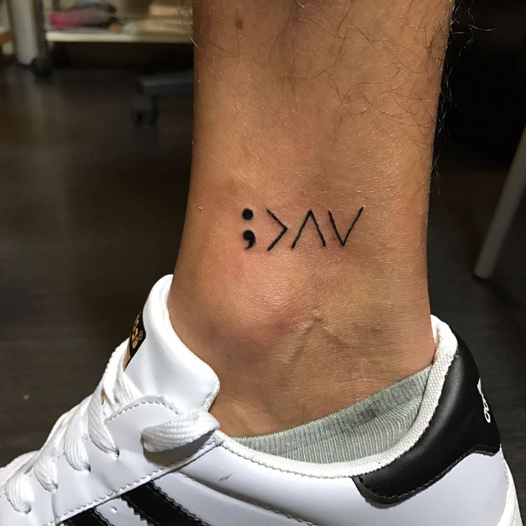 a person with a tattoo on their ankle that reads vak and is written in black ink