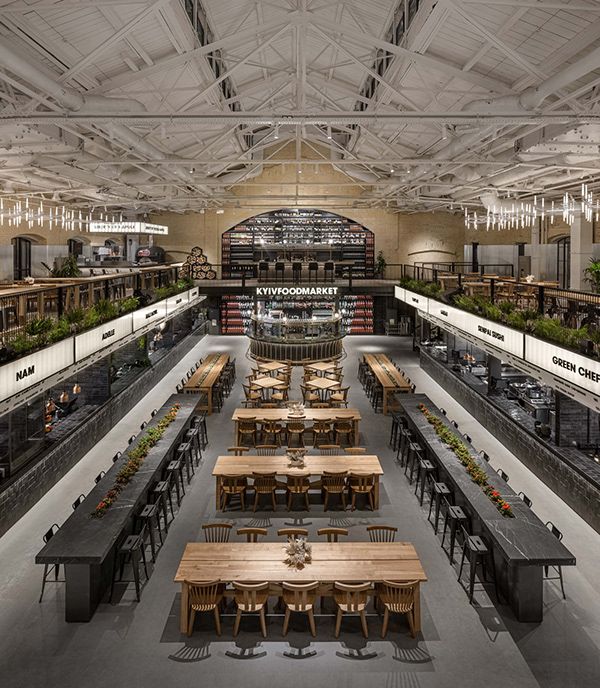 an empty restaurant with tables and chairs in the center, surrounded by shelves full of books