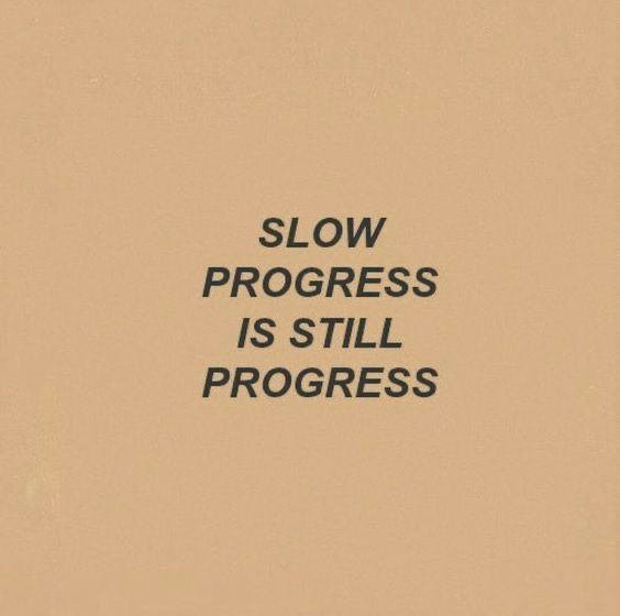 the words slow progress is still progress written in black on a beige background with an orange border