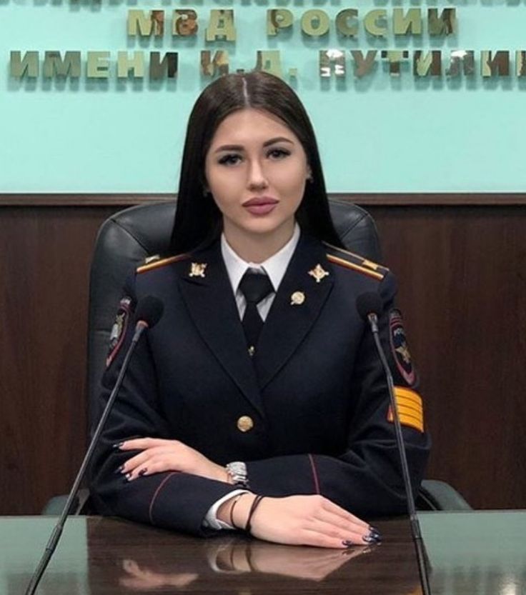 a woman in uniform sitting at a desk