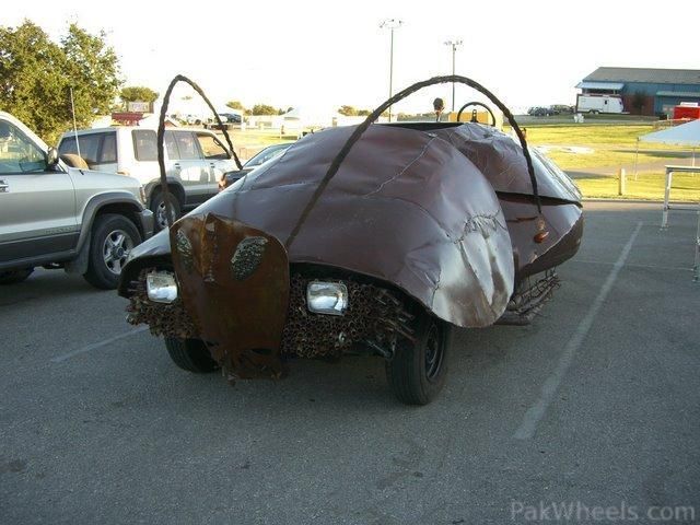 an unusual car is parked in a parking lot