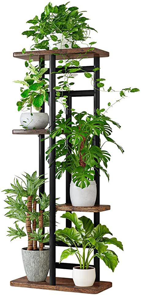 a tall shelf filled with potted plants on top of wooden shelves next to each other