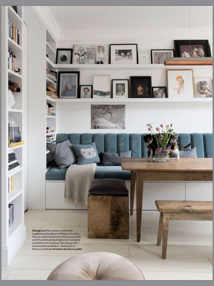 a living room filled with furniture and pictures on the wall