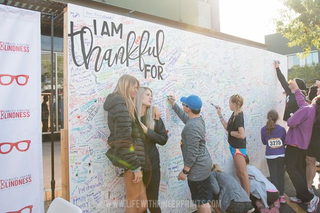 a group of people writing on a wall