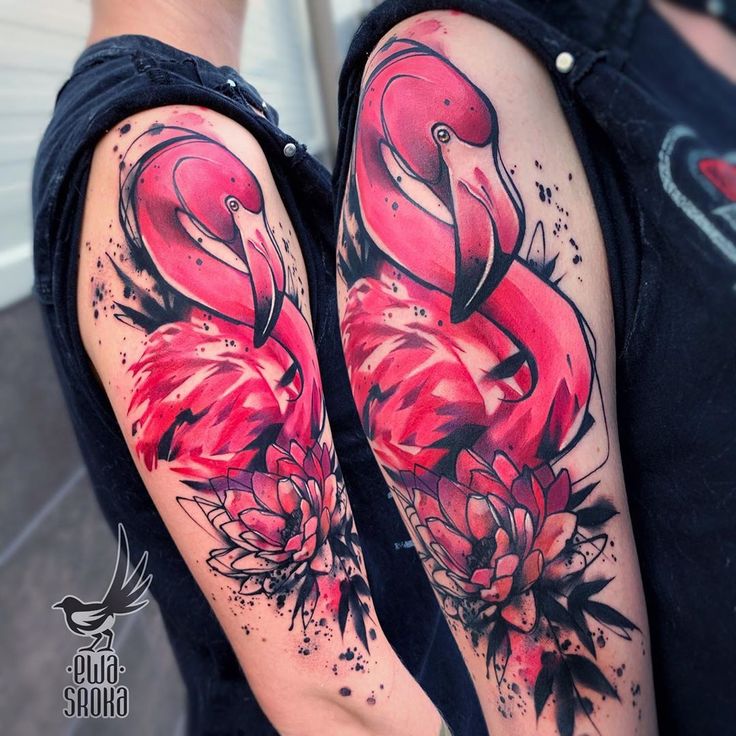 two flamingos with flowers on their arms, one is pink and the other is black