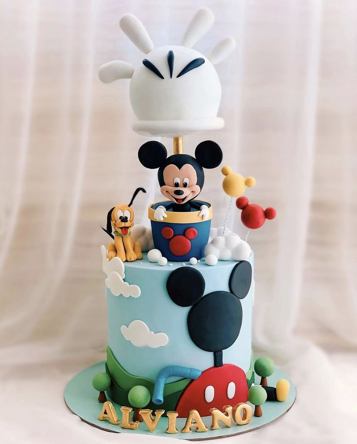 a mickey mouse birthday cake on a table