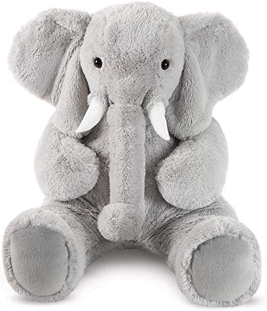 an elephant stuffed animal sitting in front of a white background