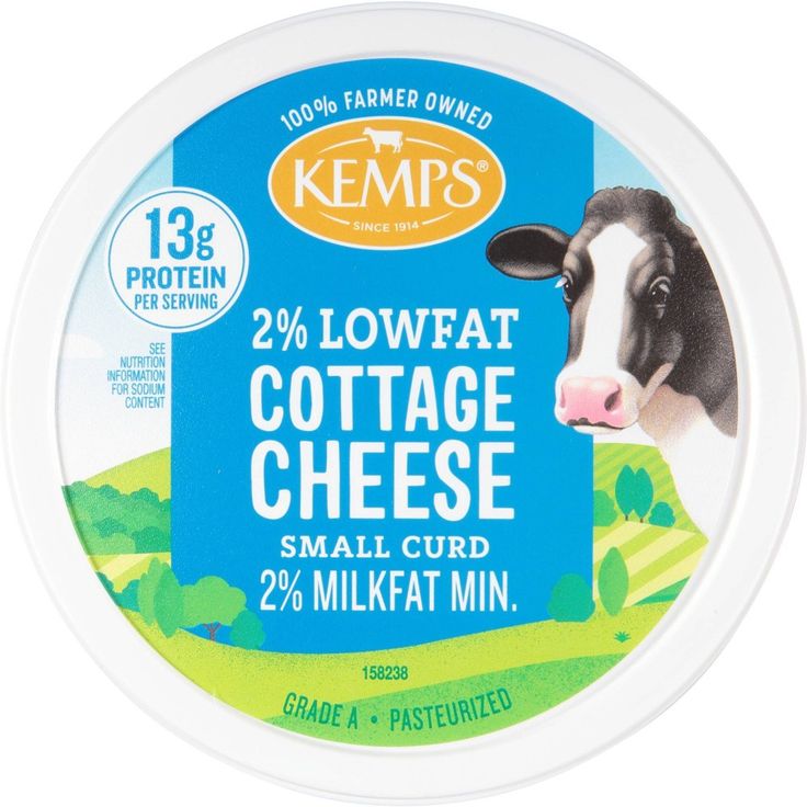 a close up of a container of cheese with a cow in the background on a white background