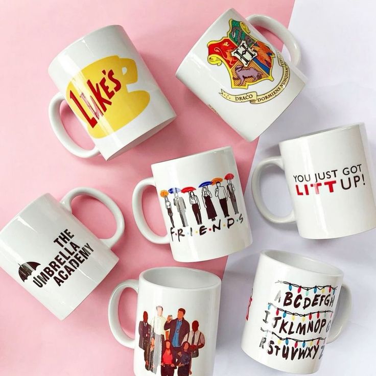 five coffee mugs with the characters of tv show friends on them, all printed in different colors