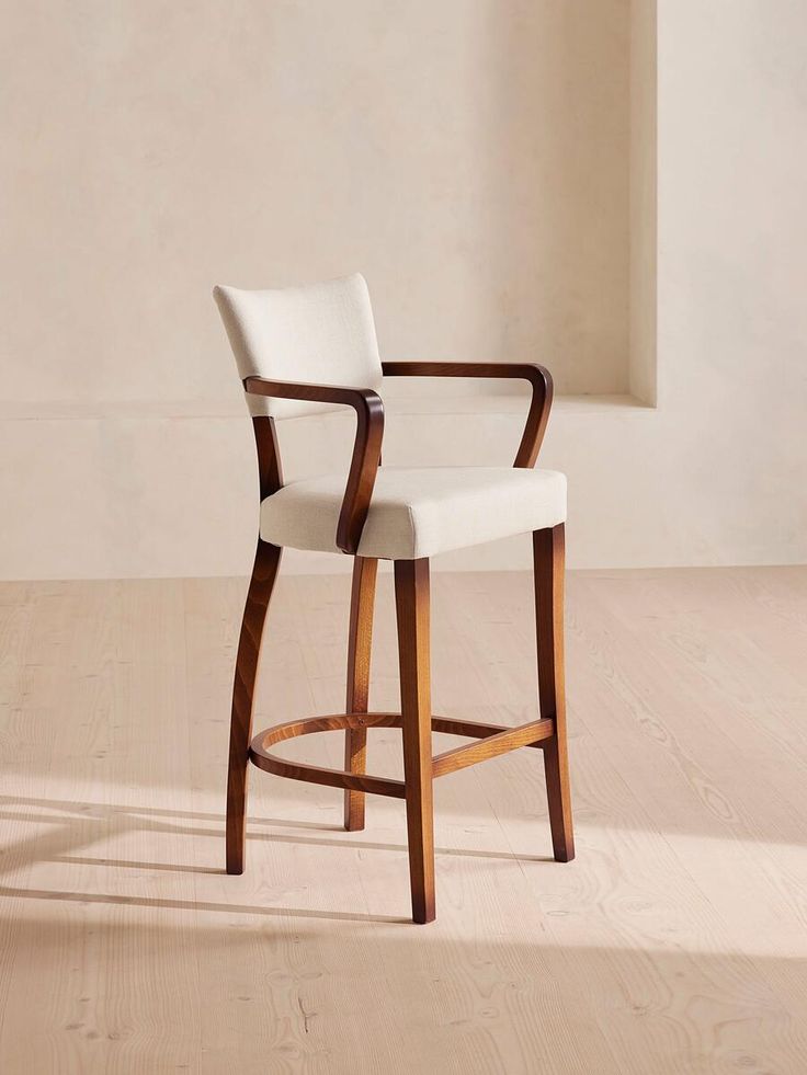 a white chair sitting on top of a hard wood floor