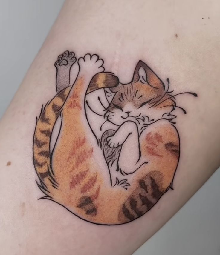 a cat tattoo on the leg of a woman