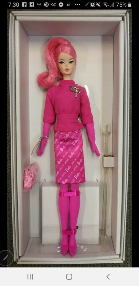 a barbie doll in a box with pink hair