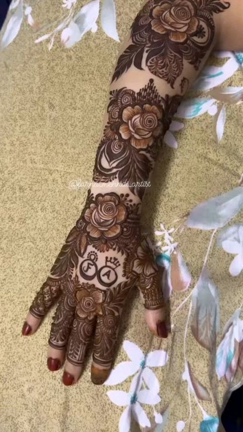 a woman's hand with henna tattoos on it