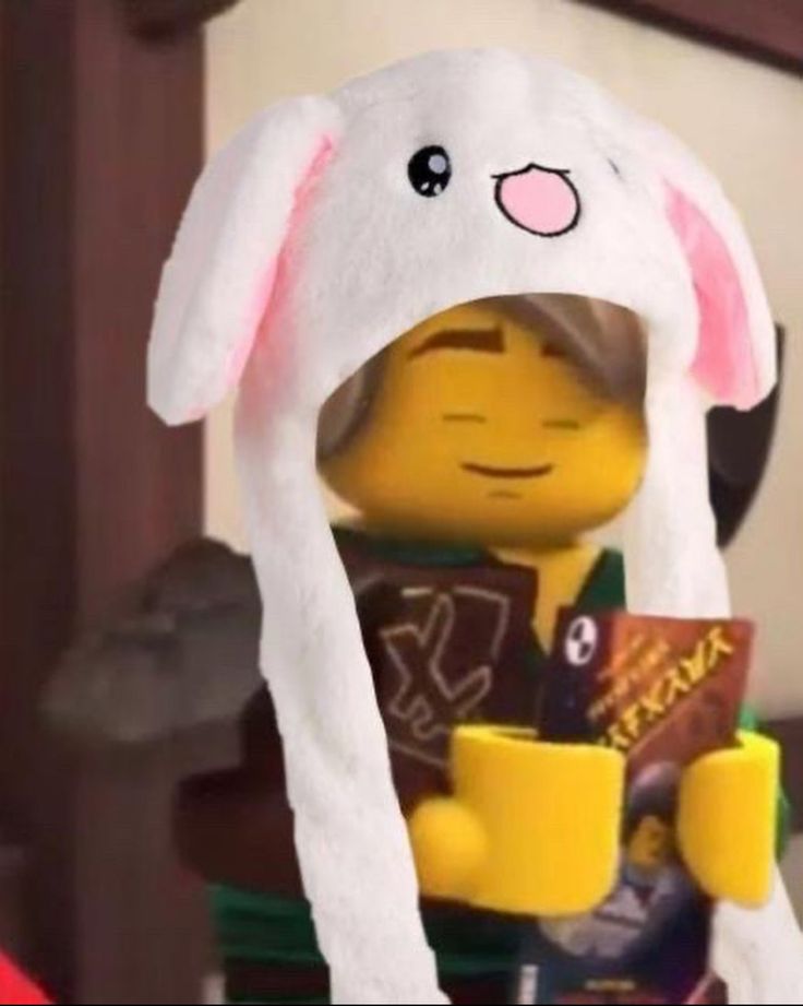 the lego character is holding a coffee cup and wearing a bunny costume on it's head