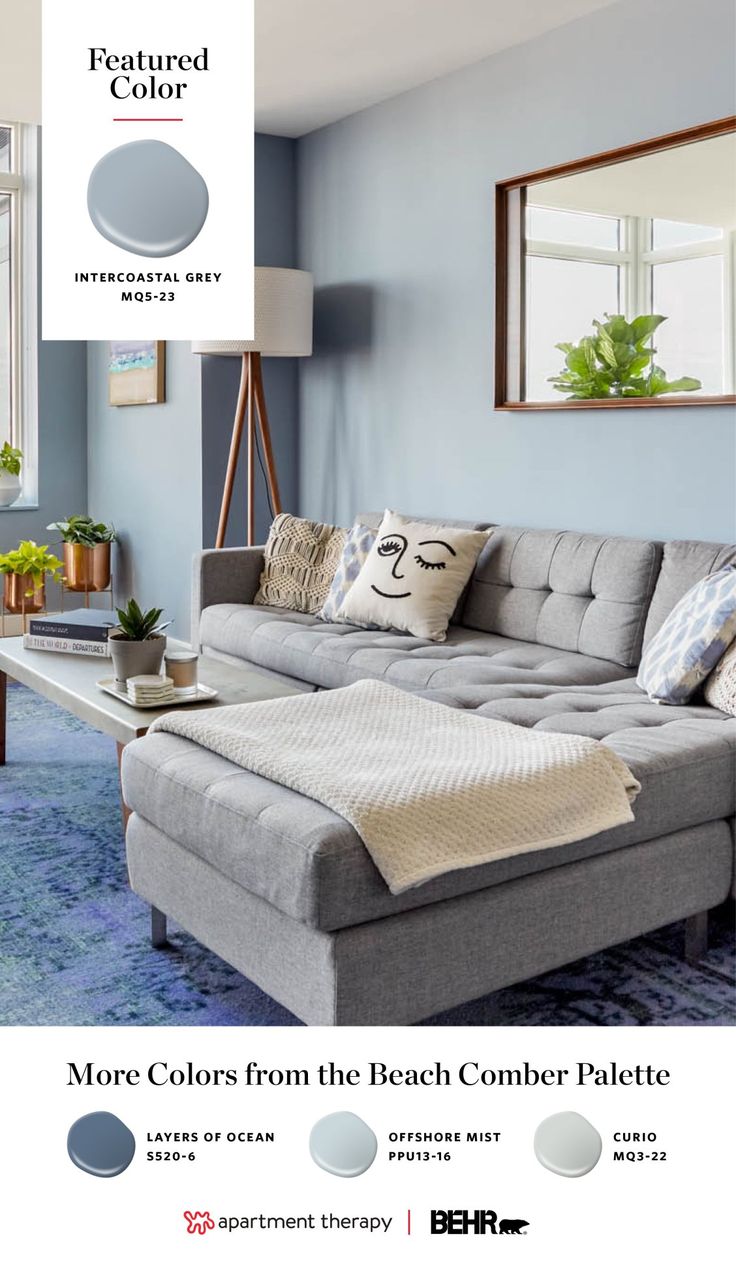 a living room with blue walls and gray furniture in the center is an advertisement for behr