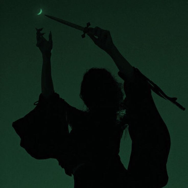 the silhouette of a woman holding a knife in her hand, against a dark green background