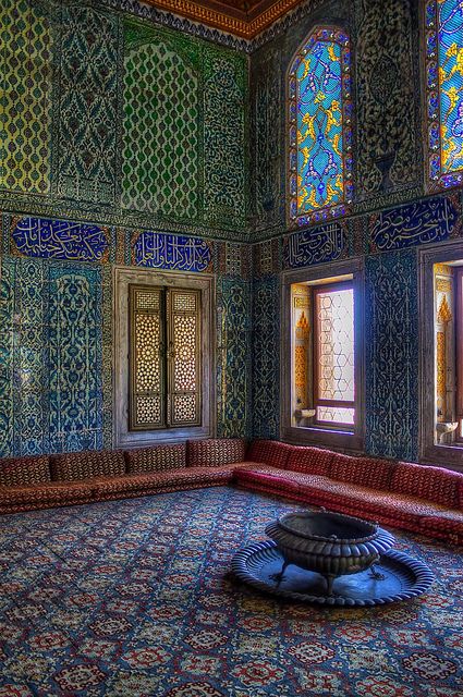 an ornate room with colorful stained glass windows