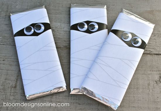 three wrapped candy bars with googly eyes on them