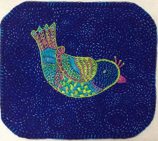 a blue square with a colorful bird on it's side and an intricate design