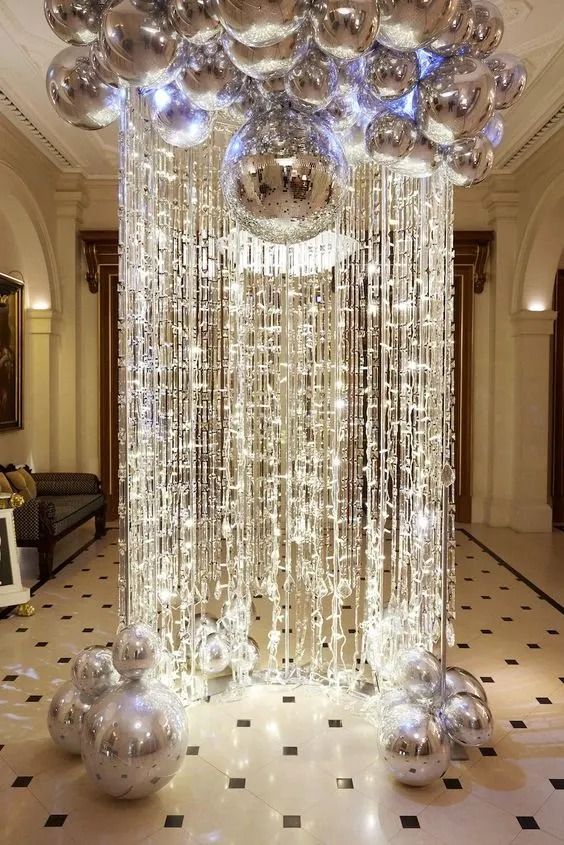 a large chandelier in the middle of a room filled with balls and lights