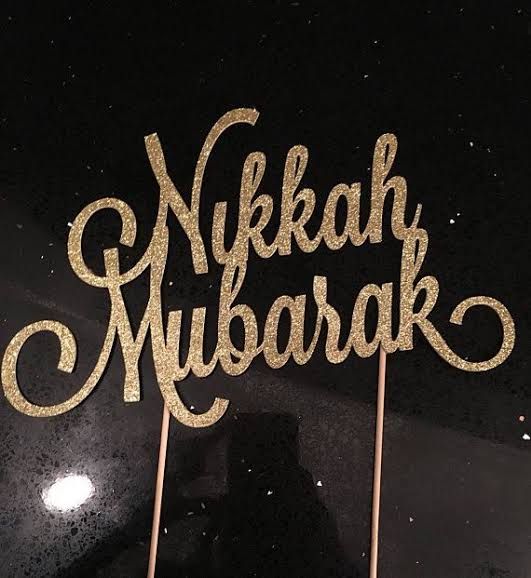 a cake topper that says nikkah mubarak on it