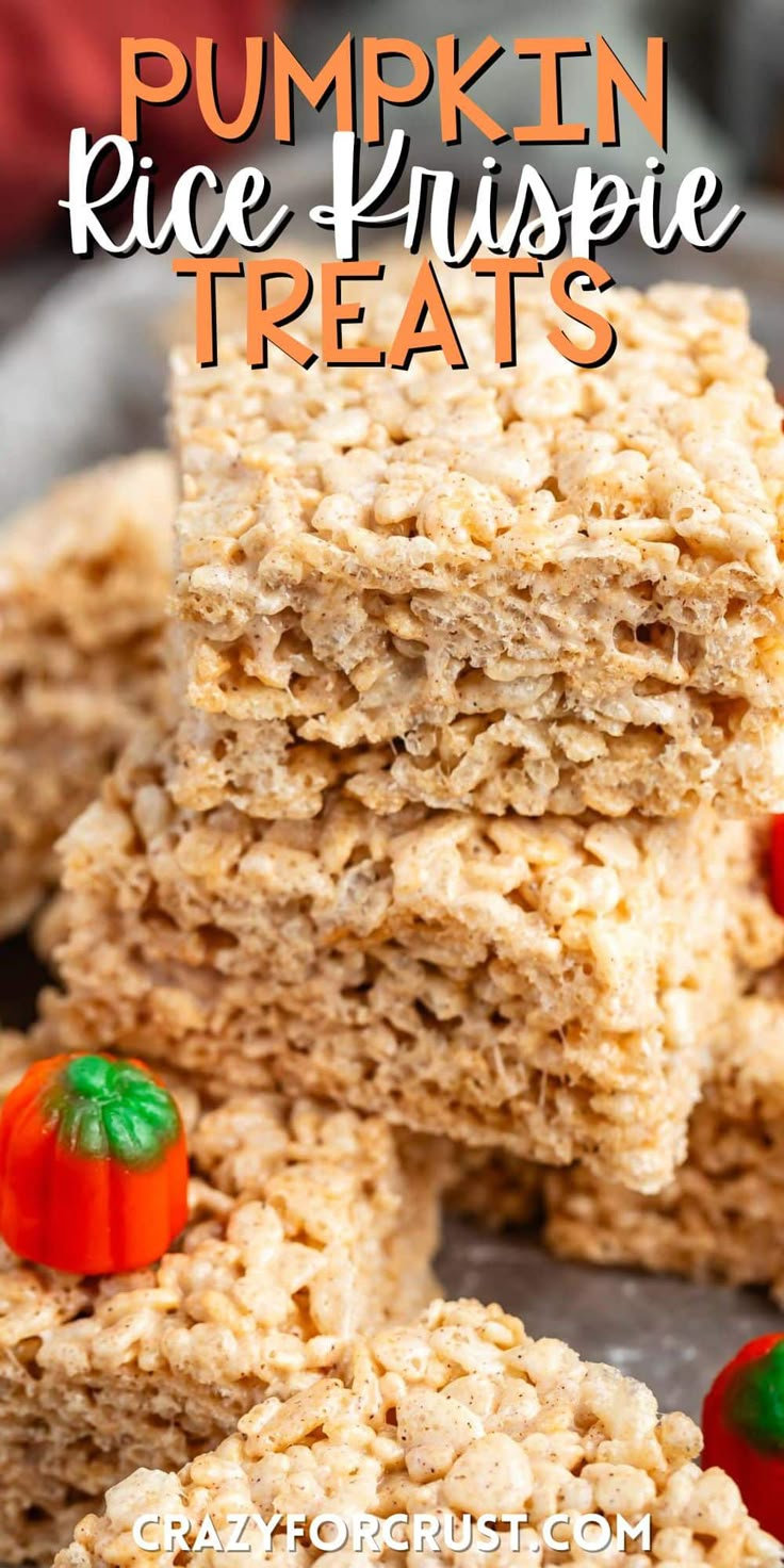 pumpkin rice krispy treats stacked on top of each other with candy candies around them