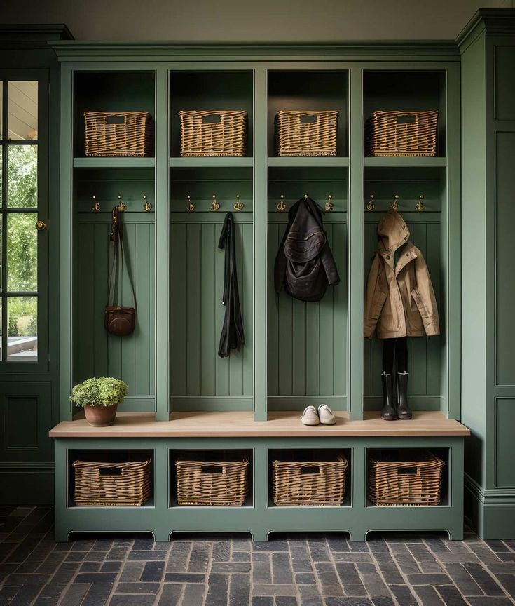 a coat rack with baskets and coats hanging on it's sides next to a bench