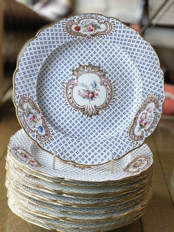 a stack of plates sitting on top of a wooden table