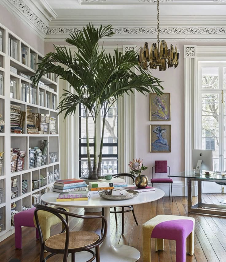 a living room filled with lots of furniture and a tree in the middle of it