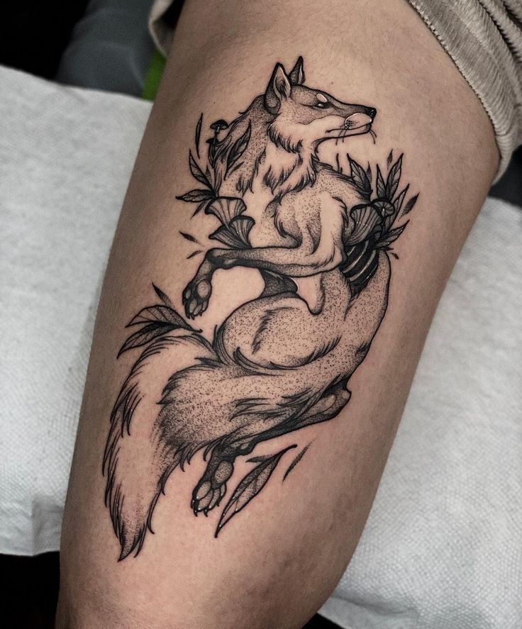 a black and white tattoo of a fox sitting on top of a tree branch with leaves