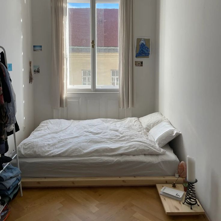 a small bedroom with a bed and window