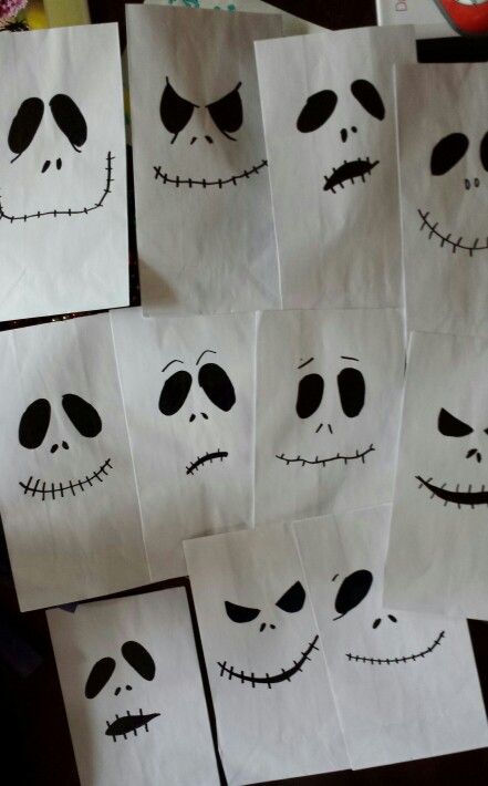 several paper bags with faces drawn on them