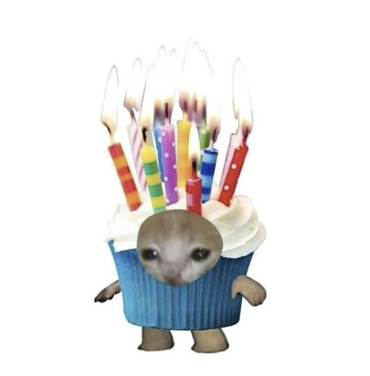 a cupcake with candles sticking out of it's face and an animal in the middle