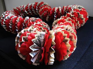 several red and white ruffled balls sitting on top of a table