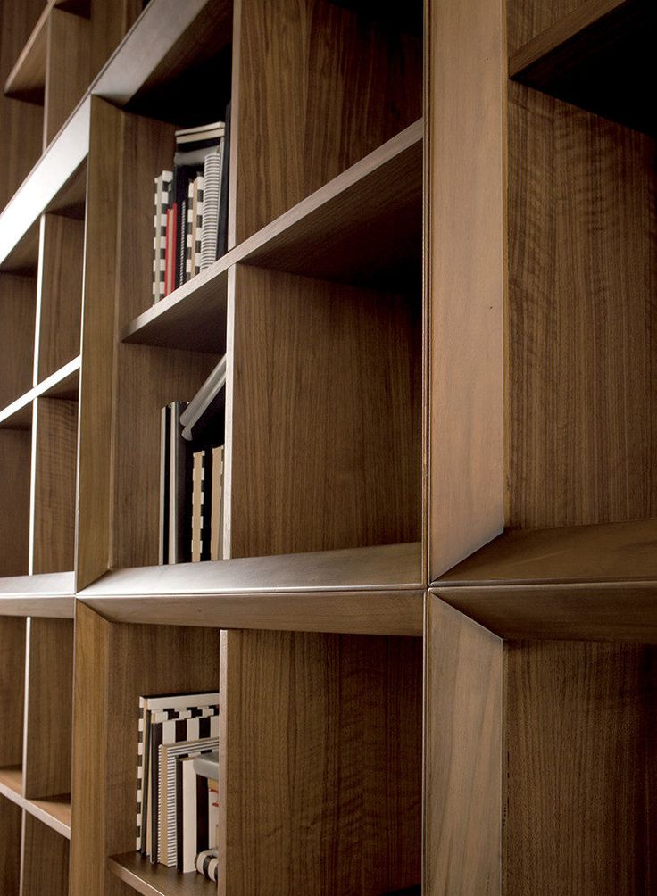 the bookshelf is made out of wood and has many shelves