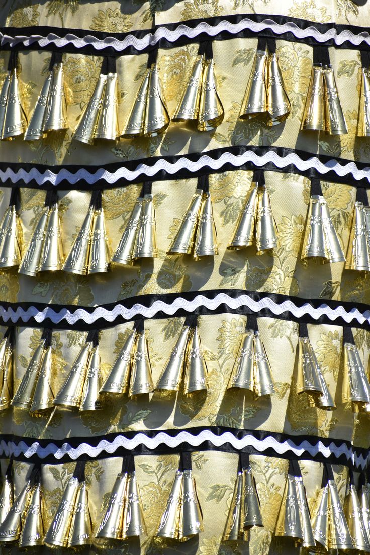 many gold and white cones are stacked on top of each other