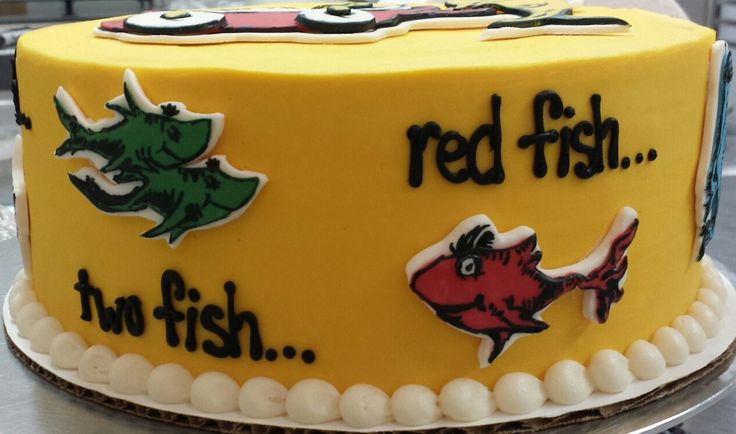 there is a yellow cake with red fish on it