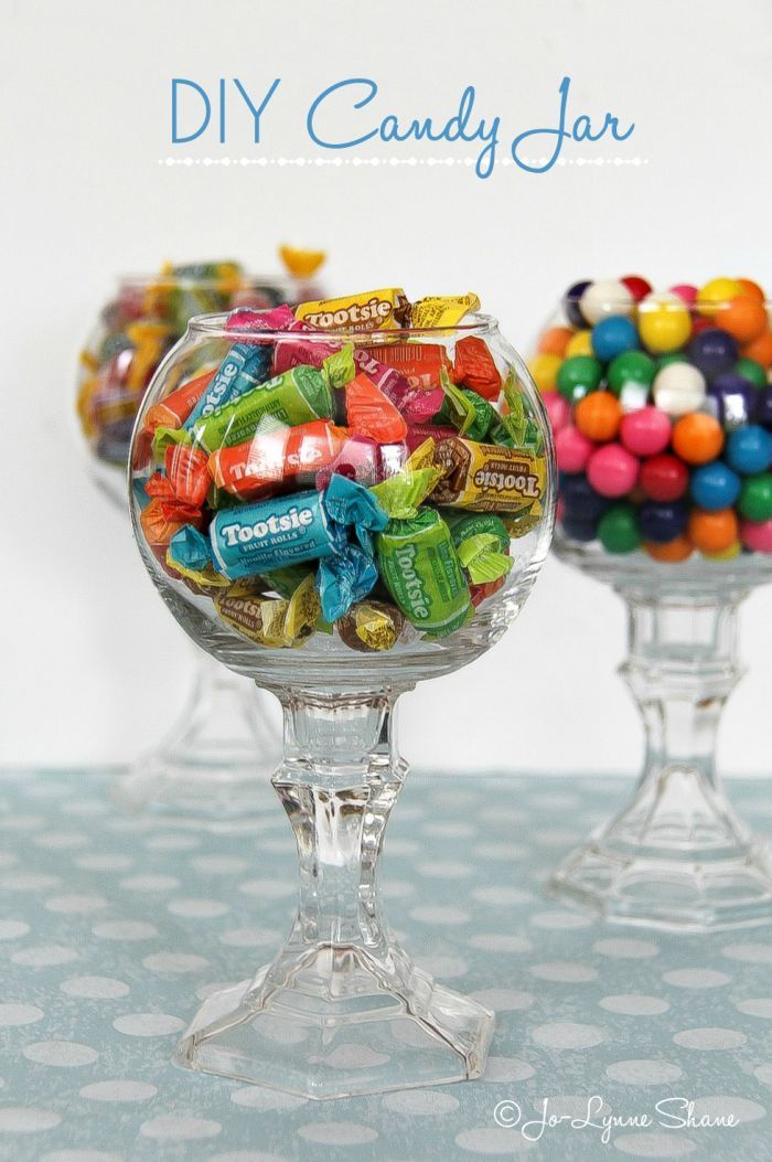 two glass bowls filled with candy on top of a table