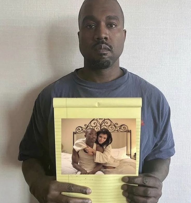 a man holding up a photo in front of his face